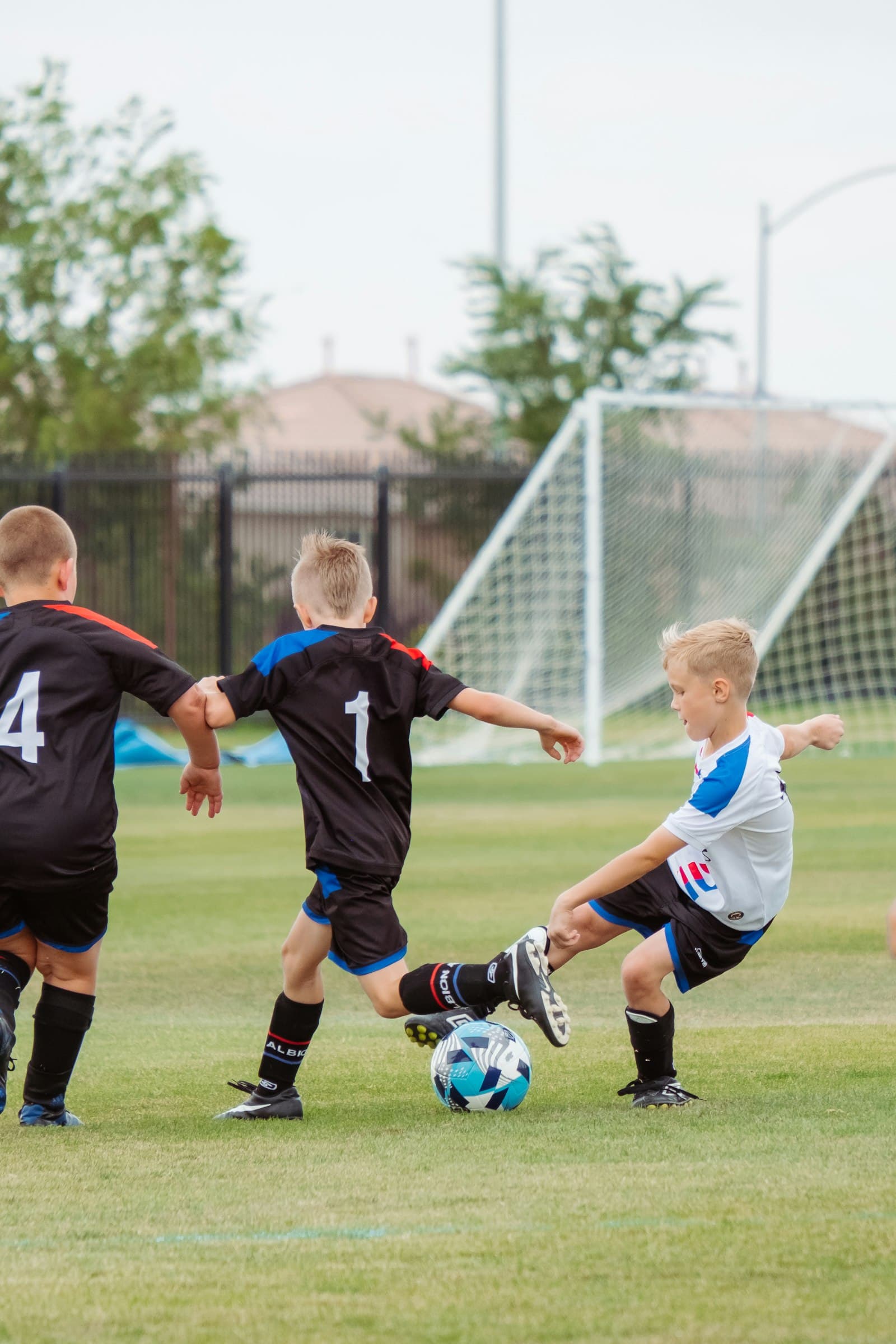 Youth soccer players competing for the ball during a match